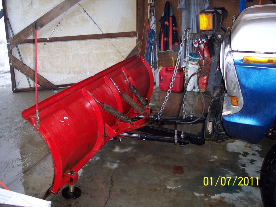 1973 Ford F-250 with a red plow attached, viewed from the front