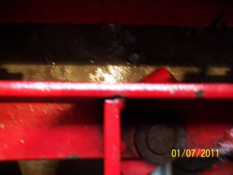 1973 Ford F-250 - Close-up of red painted metal frame with a bolt, dated 01/07/2011.