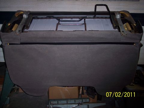 1973 Ford F-250 - Underside view of a vehicle seat frame with visible metal components and fabric covering.