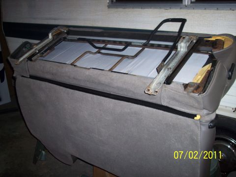 1973 Ford F-250 - Close-up of a car seat frame, showing upholstery and metal components. Date stamp visible.