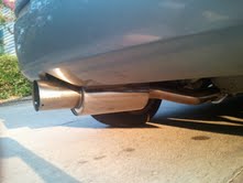 1996 Ford Bronco - The rear exhaust pipe of a vehicle is shown from a low angle.