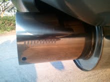 1996 Ford Bronco - Close-up view of a shiny chrome exhaust pipe on a vehicle.
