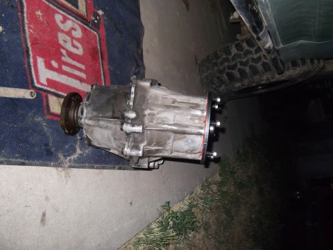 1989 Ford Bronco - Transfer case removed from a vehicle, resting on a mat with 'Tires' text visible.