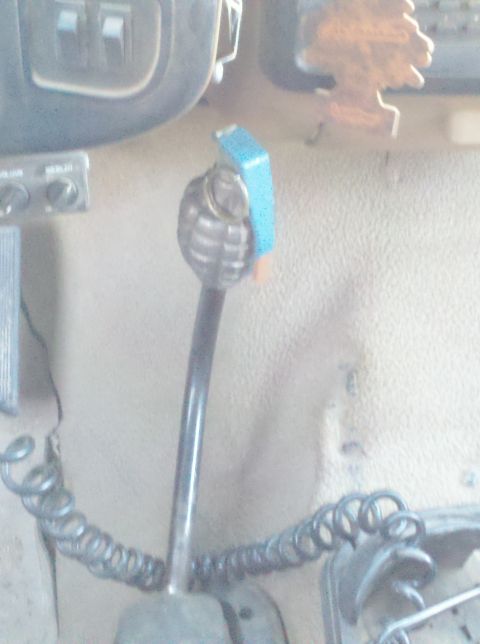 1989 Ford Bronco - Vehicle interior features a custom grenade shift knob and an air freshener hanging from the mirror.