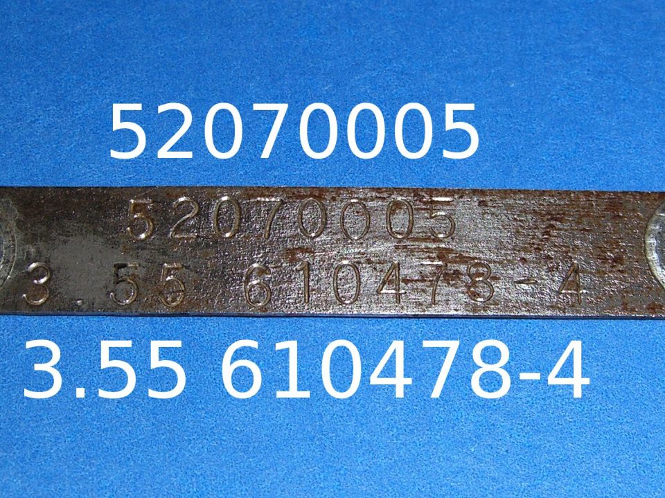 Metal tag with stamped numbers 52070005 and 3.55 610478-4