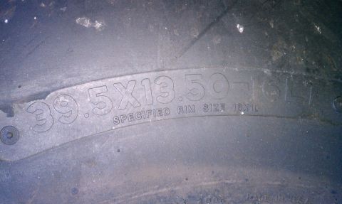 1990 Ford Bronco - The tire sidewall displays its dimensions and the recommended rim size for installation.