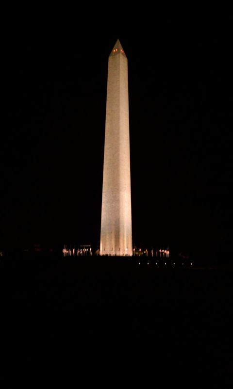 1990 Ford Bronco - The Washington Monument stands tall against the night sky, illuminated by lights.