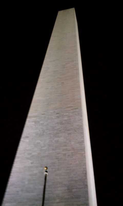 1990 Ford Bronco - The Washington Monument stands tall against the night sky, its stone facade illuminated.