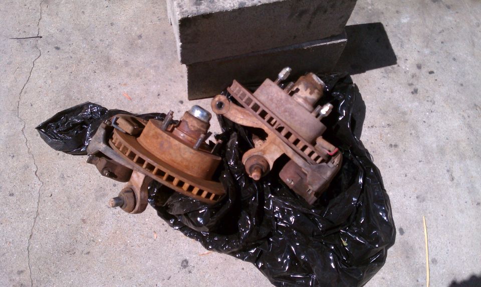 Rusty brake rotors and calipers on black plastic