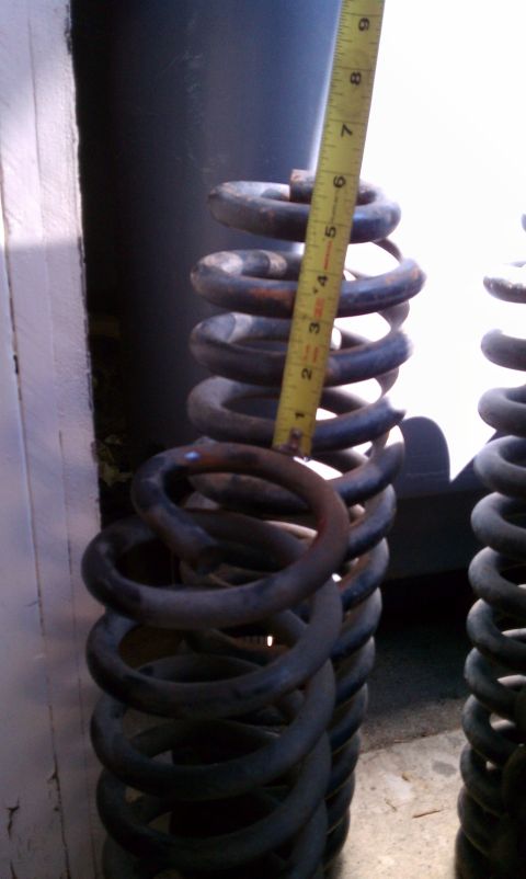 1990 Ford Bronco - Measuring suspension coil springs, possibly for a vehicle modification or repair.