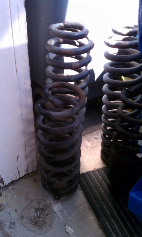 1990 Ford Bronco - Two heavy-duty coil springs are shown, likely for a vehicle suspension system.