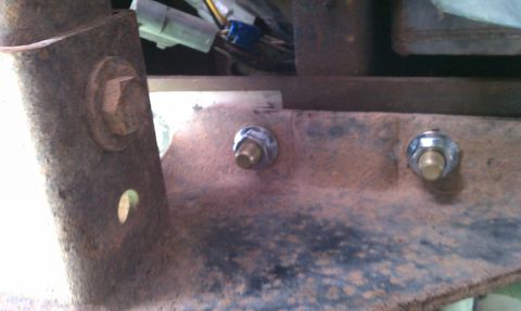 1990 Ford Bronco - Detail of a corroded metal component with electrical connections visible in the background.