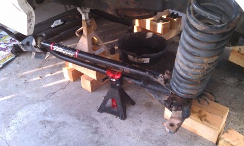 1990 Ford Bronco - Vehicle suspension components are shown on jack stands, indicating repair or modification work.