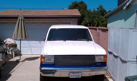 1990 Ford Bronco - Front view of a 1990 Ford Bronco parked in a driveway.