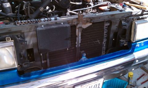 1990 Ford Bronco - The engine bay of a 1990 Ford Bronco, with the radiator and transmission cooler visible during a rebuild project.