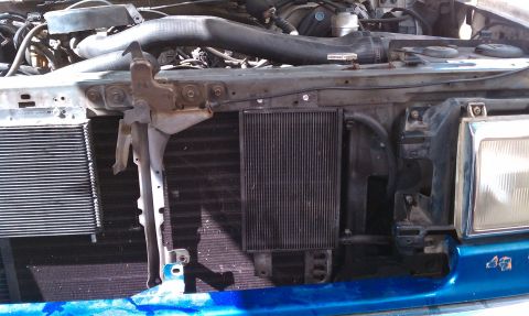 1990 Ford Bronco - Front view of the engine bay, focusing on the radiator and condenser in a 1990 Ford Bronco.