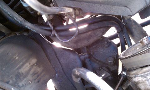 1990 Ford Bronco - Close-up view of engine bay components, including hoses and power steering parts.