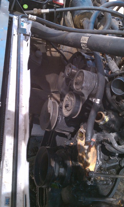 1990 Ford Bronco - Close-up view of an engine bay, showing the radiator and serpentine belt system.