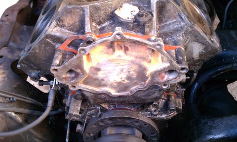 1990 Ford Bronco - Close-up view of an engine block's water pump mounting surface, revealing the gasket's imprint and internal coolant passages.