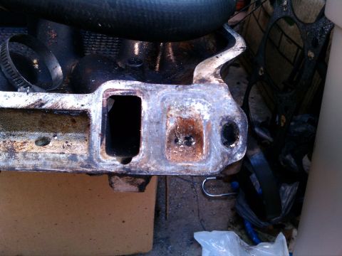1990 Ford Bronco - Close-up of a used engine intake manifold, indicating a need for repair or replacement.