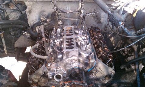 1990 Ford Bronco - Close-up view of an engine's intake manifold and valve train during a rebuild.