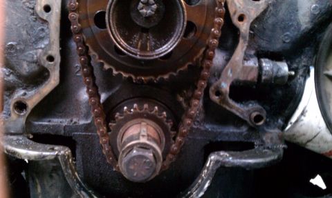 1990 Ford Bronco - This image shows the internal engine components, specifically the timing chain and gears, in a state of repair or disassembly.