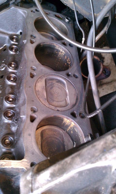 1990 Ford Bronco - Close-up view of an engine block, revealing the pistons within the cylinders.