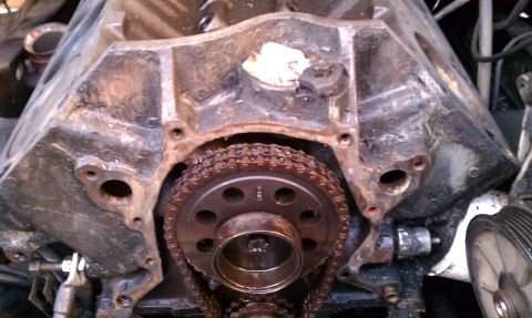 1990 Ford Bronco - The engine's timing chain and gears are visible on the block.