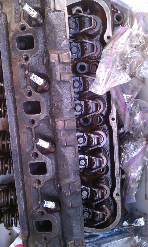 1990 Ford Bronco - Close-up of an engine cylinder head, showing spark plugs and internal valve train components.