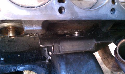 1990 Ford Bronco - This is a close-up view of a vehicle's engine block, showing an oil filter housing and surrounding components.