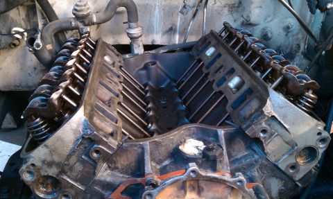 1990 Ford Bronco - Close-up view of an engine block, revealing the internal valve train components like pushrods and springs.