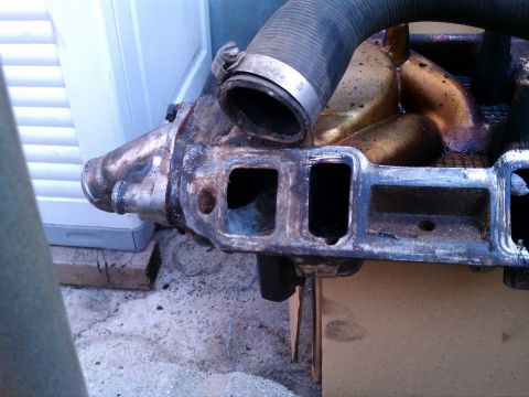 1990 Ford Bronco - Close-up of an engine intake manifold, likely removed for repair or replacement.