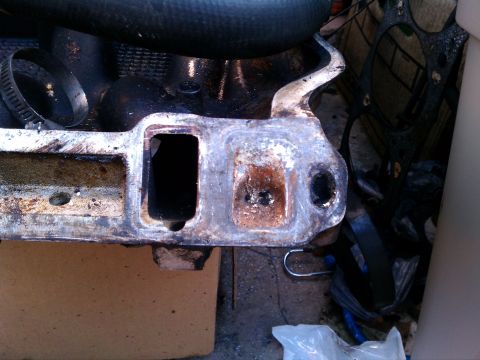 1990 Ford Bronco - This is a close-up view of a used engine intake manifold, showing signs of wear and tear.