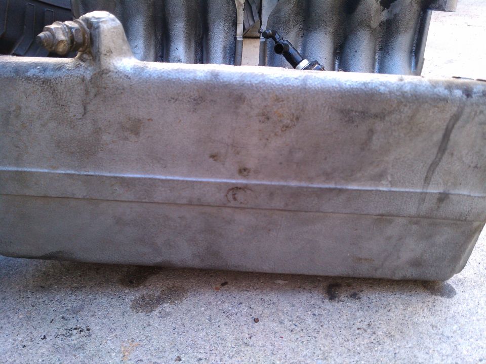 Aluminum intake manifold with bolt and hose fitting