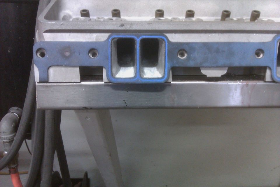 Close-up of an engine intake manifold gasket on a metal surface