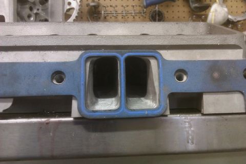 1996 Chevrolet Camaro - Close-up of an engine intake manifold, showing the gasket and port openings.