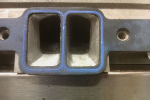 1996 Chevrolet Camaro - Close-up view of intake manifold ports, showing the blue gasket seal.