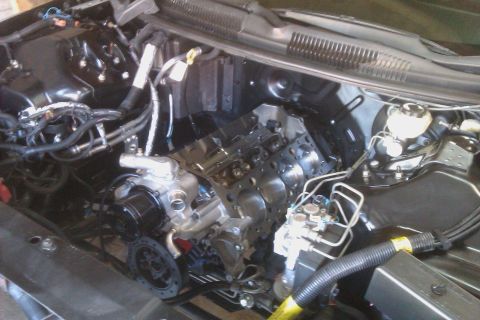 1996 Chevrolet Camaro - The engine bay of a vehicle shows the engine block and associated components, with some text visible at the bottom right.