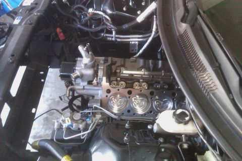 1996 Chevrolet Camaro - The engine bay of a vehicle is shown with the engine block partially disassembled, revealing internal components and wiring.
