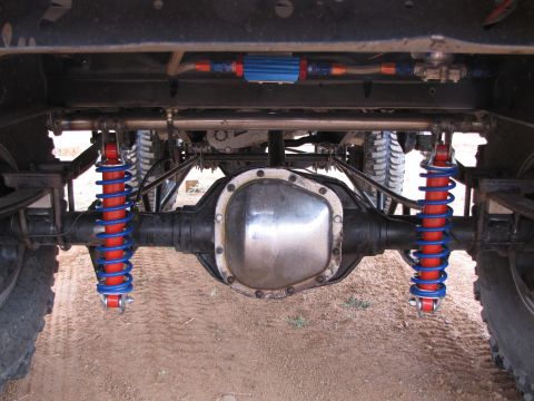 1995 Ford Bronco - Customized rear suspension components, including bright red and blue shocks, are visible on this vehicle.