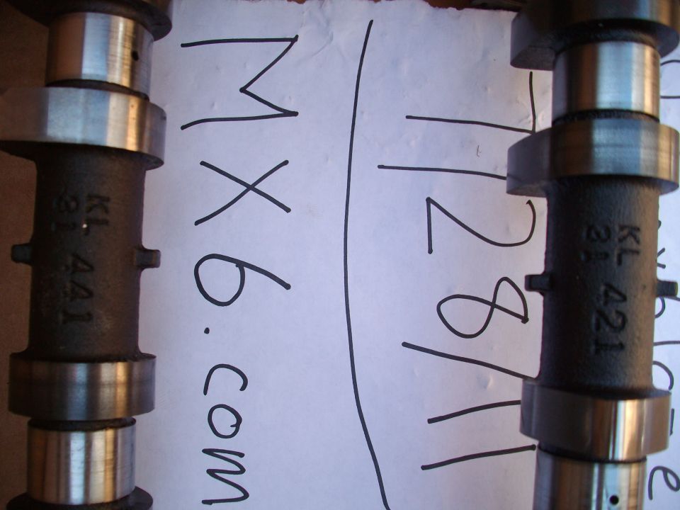 Two camshafts with markings KL 421 and MX6.com