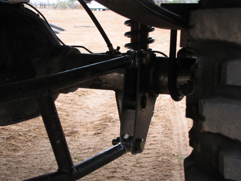 Close-up of aftermarket rear suspension linkage and coilover shock