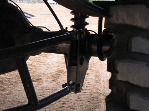 1995 Ford Bronco - This image shows the rear suspension components of a vehicle, including a shock absorber and linkage system.