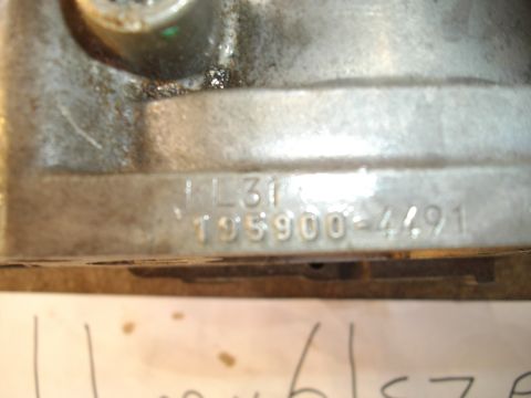 1994 Mazda MX-6 - Metal part with stamped identification numbers visible.