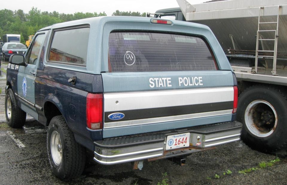Rear view of a blue and grey Ford Bronco with "STATE POLICE" on the tailgate