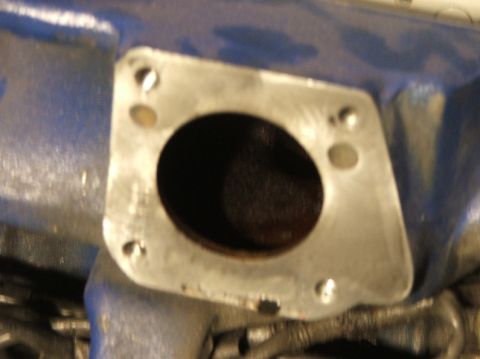 1991 Ford Festiva - Engine intake manifold flange showing the mounting surface for a component.