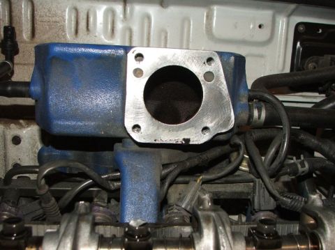 1991 Ford Festiva - This is a close-up view of an engine's intake manifold, showing its connection point.