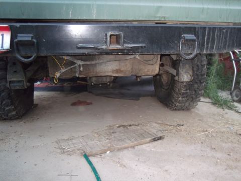 1989 Ford Bronco - Close-up of a vehicle's rear bumper, fuel tank, and tires.