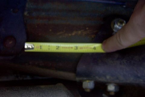 1994 Ford Bronco - A tape measure is used to measure a component, likely for automotive repair or modification.