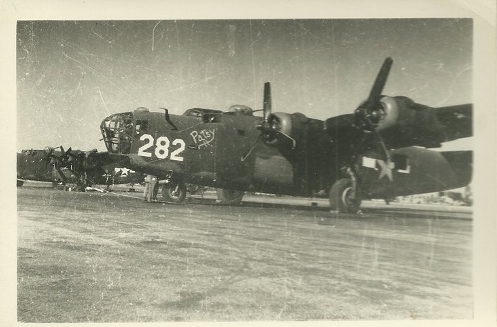 Two bomber aircraft parked on tarmac, one with '282' and 'Patsy' painted on its side